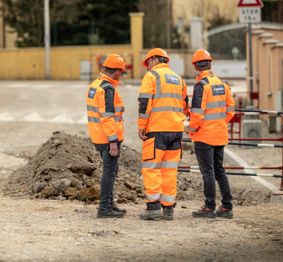 3 hommes moulin regardant le chantier