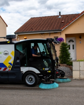 E2 sweeping along a pavement in a residential area.