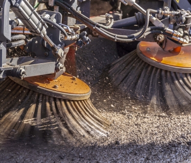 Brushes spinning, collecting road planing.