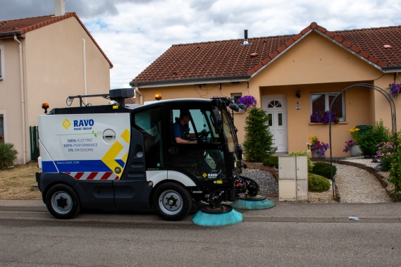 E2 sweeping along a pavement in a residential area.